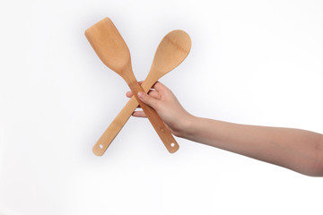 Wooden spatula in hand , isolated on white background