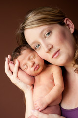 Obraz na płótnie Canvas Loving Mother Holding Newborn Baby