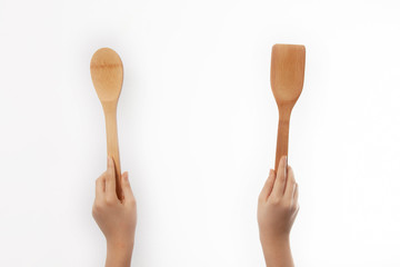 Wooden spatula in hand , isolated on white background