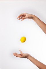 Lemon in hand isolated on white background