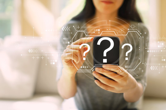 Question marks with woman using her smartphone in a living room