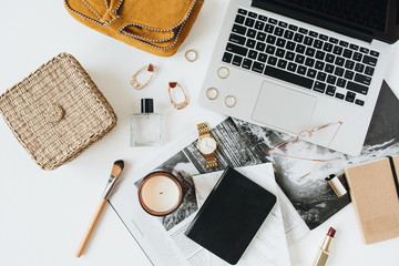 Feminine modern styled home office desk workspace with laptop, accessories on white background. Flat lay, top view. Fashion beauty blog, social media, website minimal composition. Girl boss concept.
