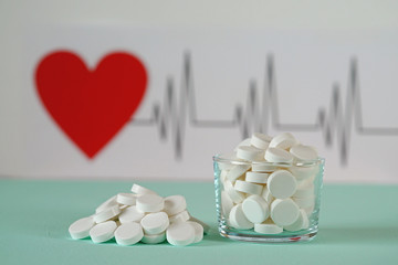 Tablets on the background of the cardiogram of the heart. Helthy heart  concept