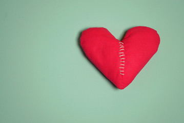 Broken heart. Stitch suture on heart shape. Love and health care concept. Top view