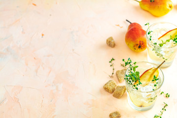 Cold pear white tea with thyme on the pink concrete table