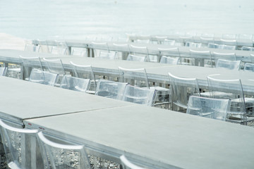 The transparent chairs for the party are rows on the beach