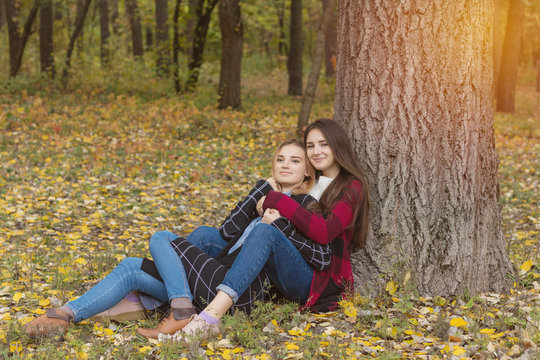 Two cute beautiful young women relaxing in park