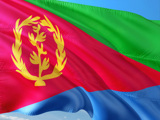 Flag of Eritrea waving in the wind against deep blue sky. High quality fabric.