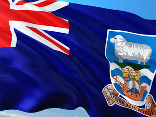 Flag of Falkland Islands waving in the wind against deep blue sky. High quality fabric.