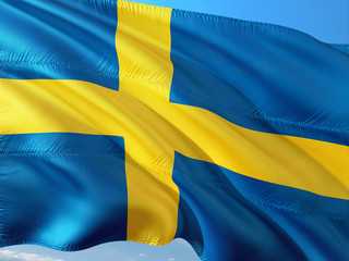 Flag of Sweden waving in the wind against deep blue sky. High quality fabric.