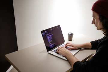 Programmer and coder working in the development environment. Programmer's workplace