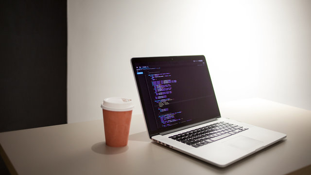 Programmer's workplace, laptop with project code. Development of websites and applications