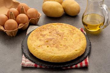 Spanish tortilla dish of potatoes with its ingredients: olive oil, potatoes and salt