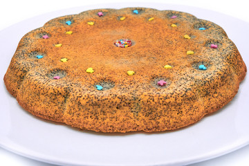 Homemade cakes with poppy seeds on a plate close-up. Delicious pumpkin pastry. Big pumpkin pie on isolated white background.