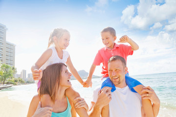 Family Of Four Enjoying A Summer Vacation In Waikiki Beach; Honolulu, Oahu, Hawaii, United States Of America