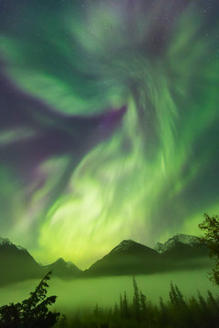 Bright Green Aurora Borealis Dances Over The Kenai Mountains, Moose Pass, Kenai Peninsula, South-Central Alaska; Alaska, United States Of America