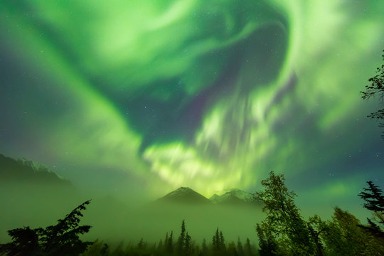 Bright Green Aurora Borealis Dances Over The Kenai Mountains, Moose Pass, Kenai Peninsula, South-Central Alaska; Alaska, United States Of America