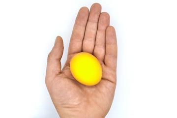Golden egg in hand - the concept of a new life. Concept of a successful idea, success and prosperity. Egg as a symbol of new life and success.