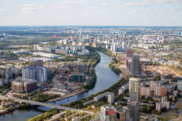 The view from the observation deck. Top view of the Moscow river. Summer in the city, sky and clouds. Sunny day, new construction home.