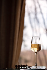 Glass of white wine opposite the window