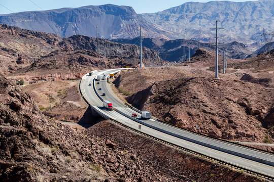 The Arizona Freeway Just Crossing The Border From Nevada Into Arizona Near The Hoover Dam, Leading Through The Mountain Terrain; Arizona, United States Of America