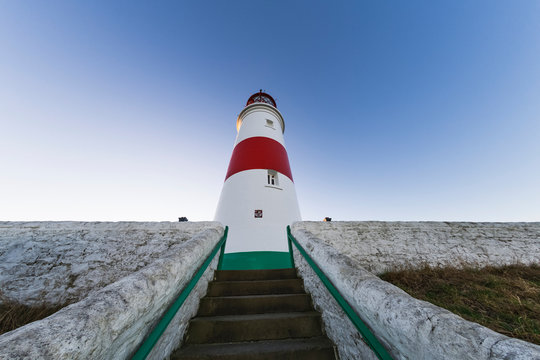 Low Angle View Of Steps Leading To A Lighthouse Against A Blue Sky; South Shields, Tyne And Wear, England