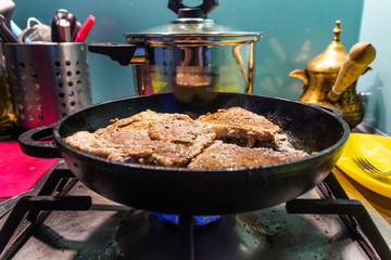 Close Pan View of Cooking Red Meat
