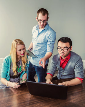 Young millennial business professionals working together in a conference room in a high tech modern business; Sherwood Park, Alberta, Canada