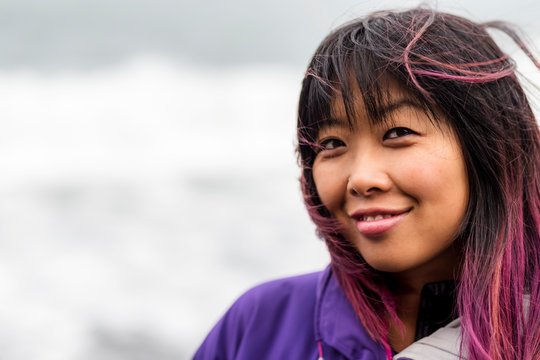 Close-up portrait of a Filipino woman with dyed pink hair; Iceland