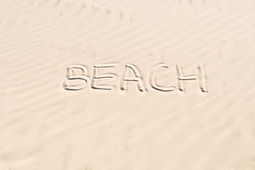Fototapeta na wymiar inscription on sand: beach