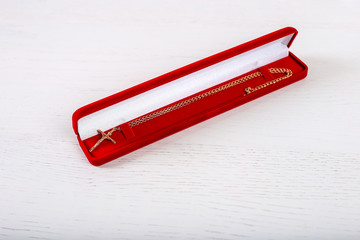 Red ring box with jewelry for concept gift wedding birthday special given isolated on white background. Pendant with Christian cross