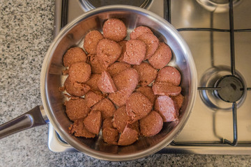 Turkish sausage or known as Turkish sucuk -  cooking with butter on a pan over cooker