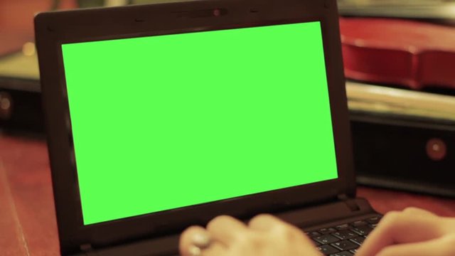 Black Netbook With Green Screen. Close-Up. Customize your Background with &ldquo;Keying&rdquo; (Chroma Key) effect in Adobe After Effects (check out tutorials on YouTube).