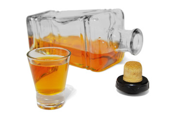 shot glass of delicious whiskey and open bottle