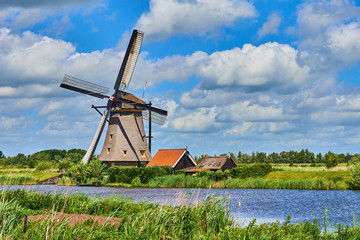 Netherlands rural lanscape with windmills at famous tourist site Kinderdijk in Holland. Old Dutch village Kinderdijk, UNESCO world heritage site. 