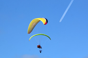 Paragliders flying in a blue sky