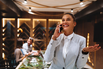 Young business woman talking on the phone at a business meeting