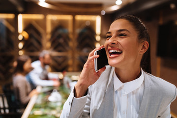 Young business woman talking on the phone at a business meeting