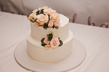Obraz na płótnie Canvas Festive wedding cake with flowers, pink-orange flowers, bunk, beautiful