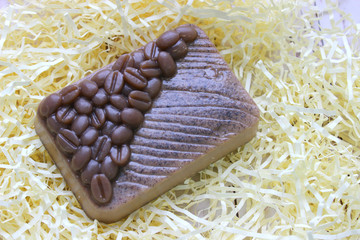 Coffee soap. Handmade soap. Coffee soap scrub isolated on a light background.coffee soap, soap for spa, coffee and milk. Copy space