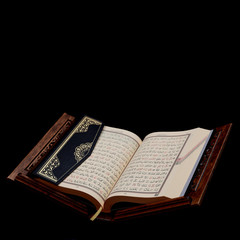 Islamic Holy Book Quran on wood carving rahle with rosary beads and prayer rug on black background. Kuran the holy book of Muslims. Ramadan concept.