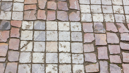 Paving stones in the old European city. Background from paving stones. Stone road in the old town. Stone pattern