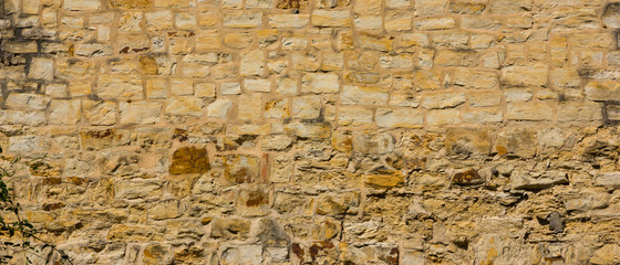 Background of old stone wall. The texture of the stone surface. Brickwork in the old European city. Pattern in retro style
