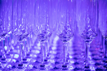 Champagne glass on the table, blue color lights