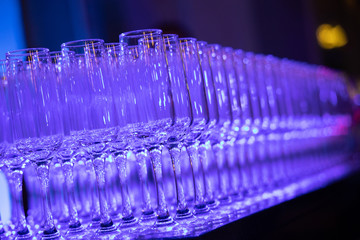 Champagne glass on the table, blue color lights