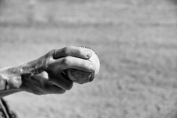 Black and white baseball concept with pitcher holding ball to throw.