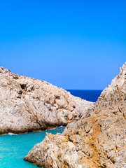 Sharp rocky edges and beautiful different shades of blue sea waters of Crete, Greece