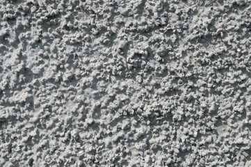 Cement plaster on concrete wall.