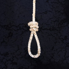 Rope for gallows with hangman noose and hanging knot isolated on a dark background