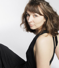 Woman in black dress on white background with filmgrain